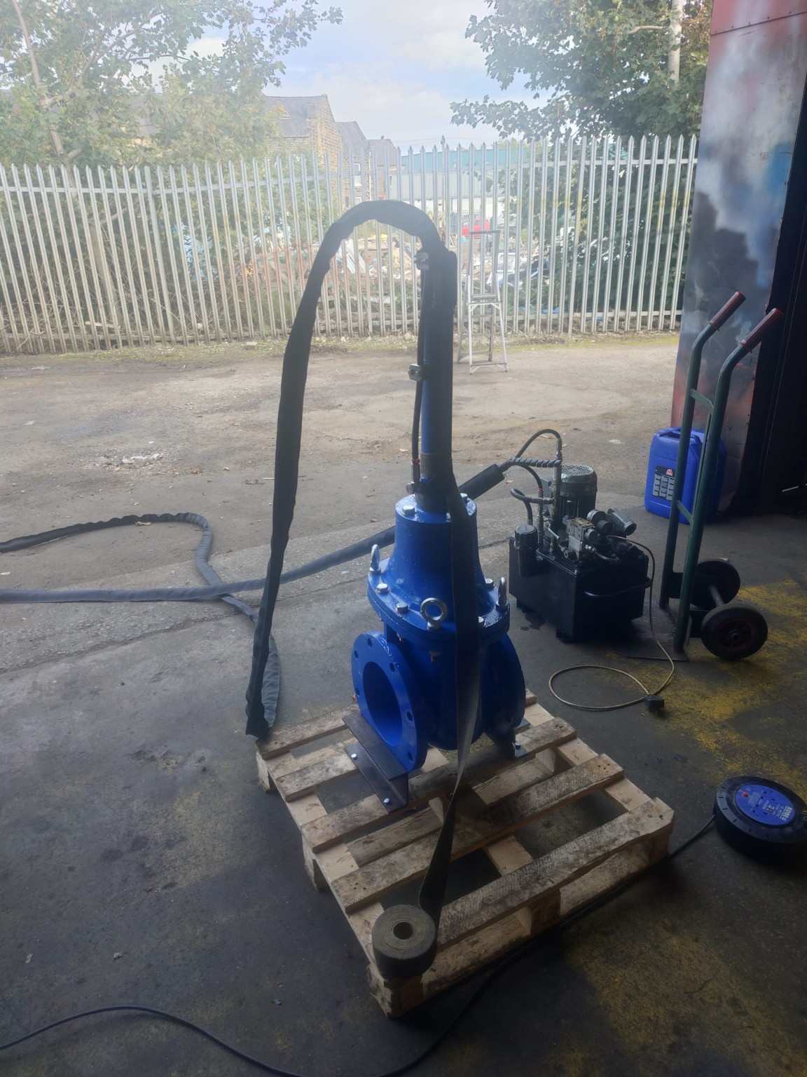 Fully assembled reservoir water valve with hydraulic hoses connected during workshop testing