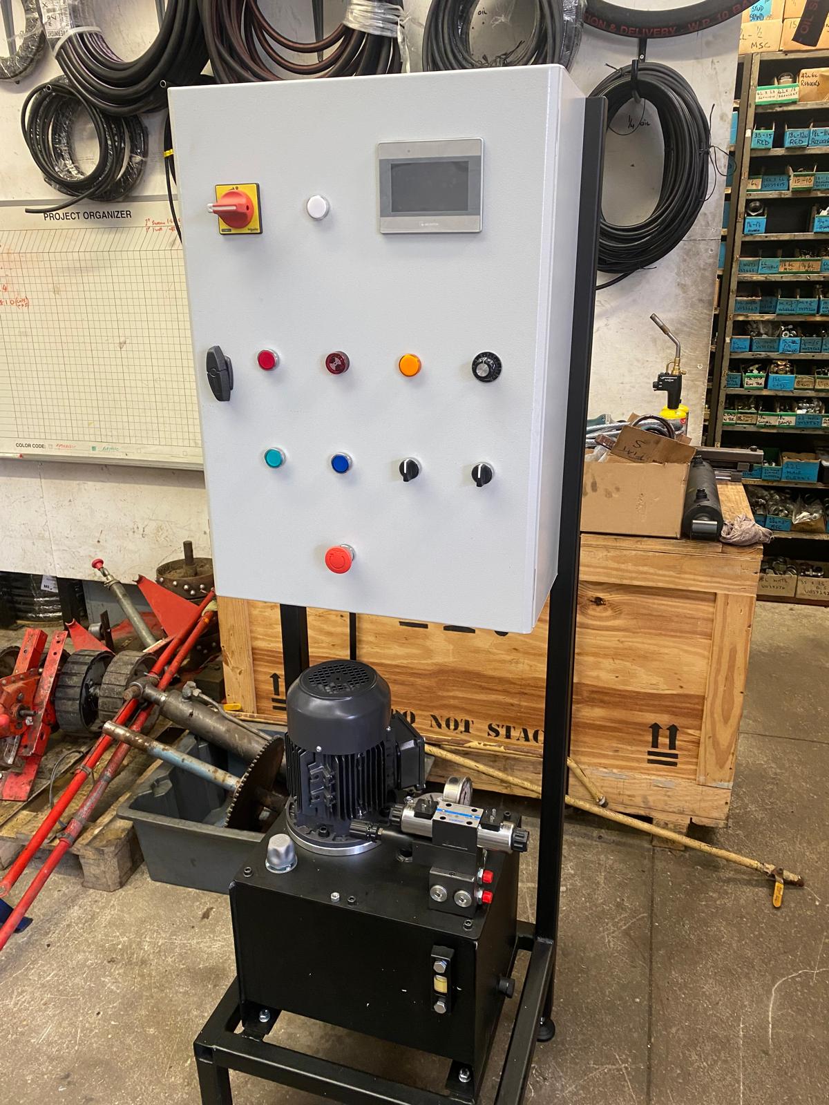The new hydraulic power pack and control-panel assembly, shown together in the workshop.