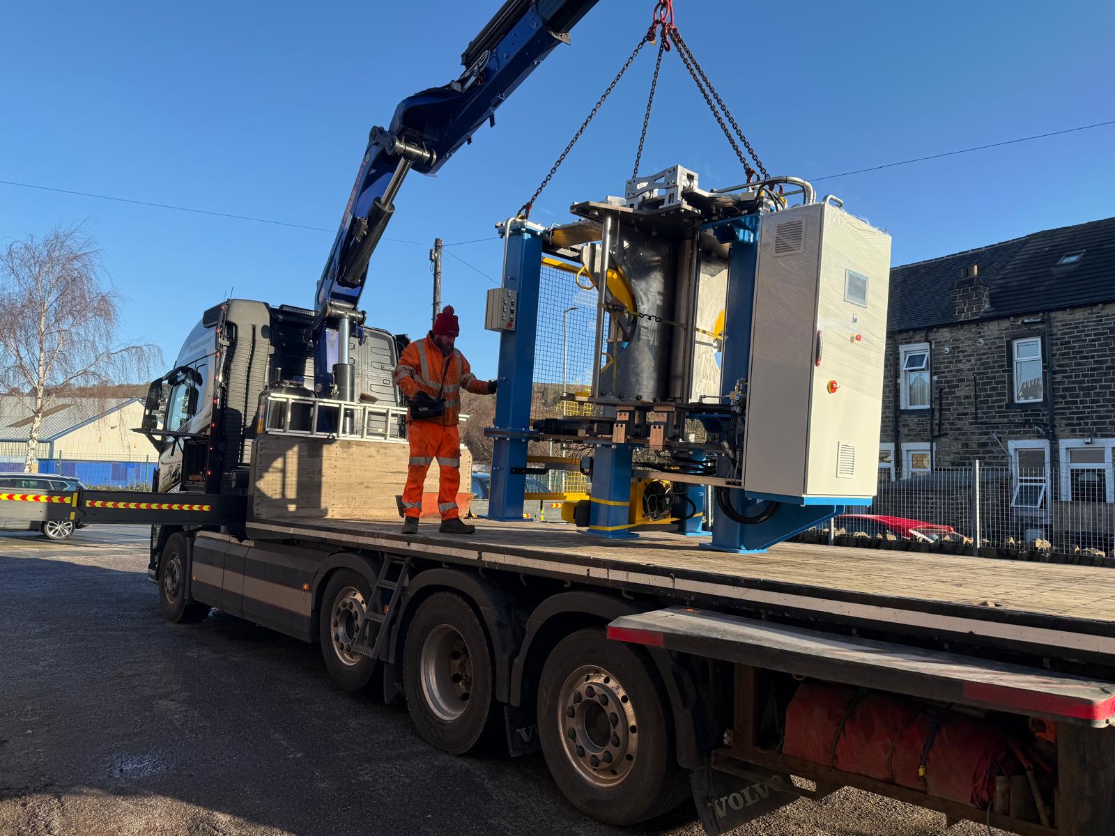 Completed spiral bending machine being loaded for transport