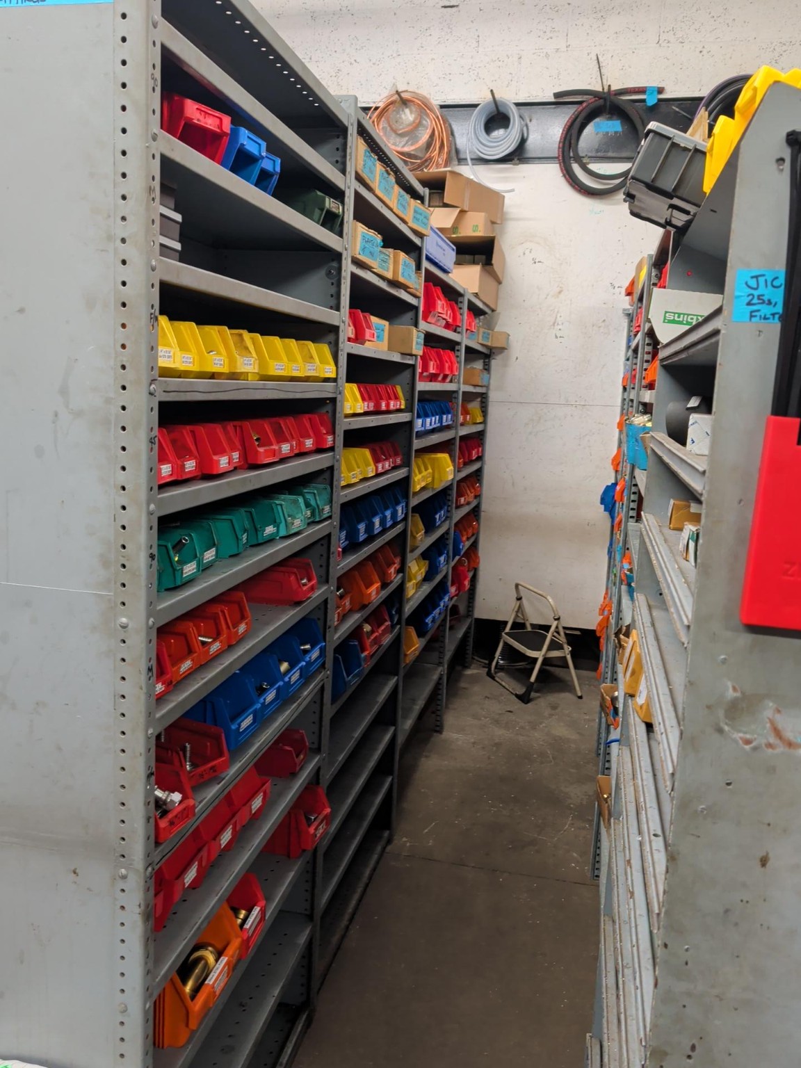 Active Hydraulics stockroom aisle filled with hydraulic components