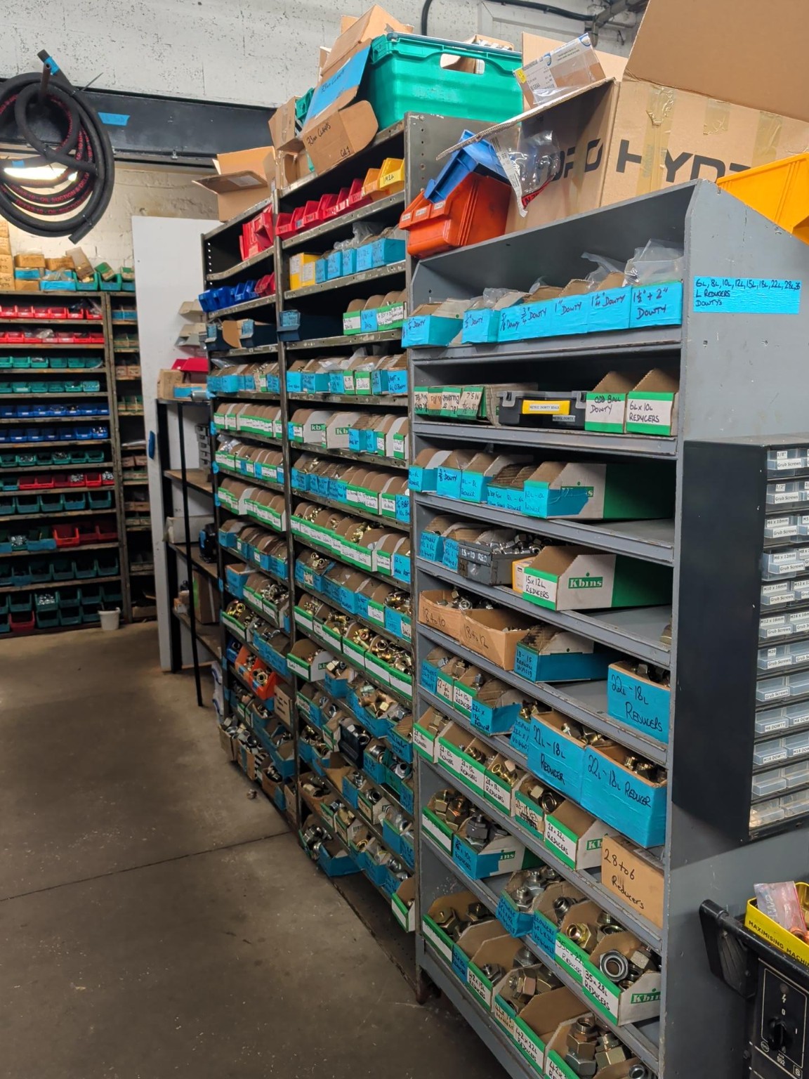 Hydraulic components stored on labelled shelves